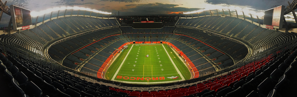 A wide view of empty Empower Field with Broncos