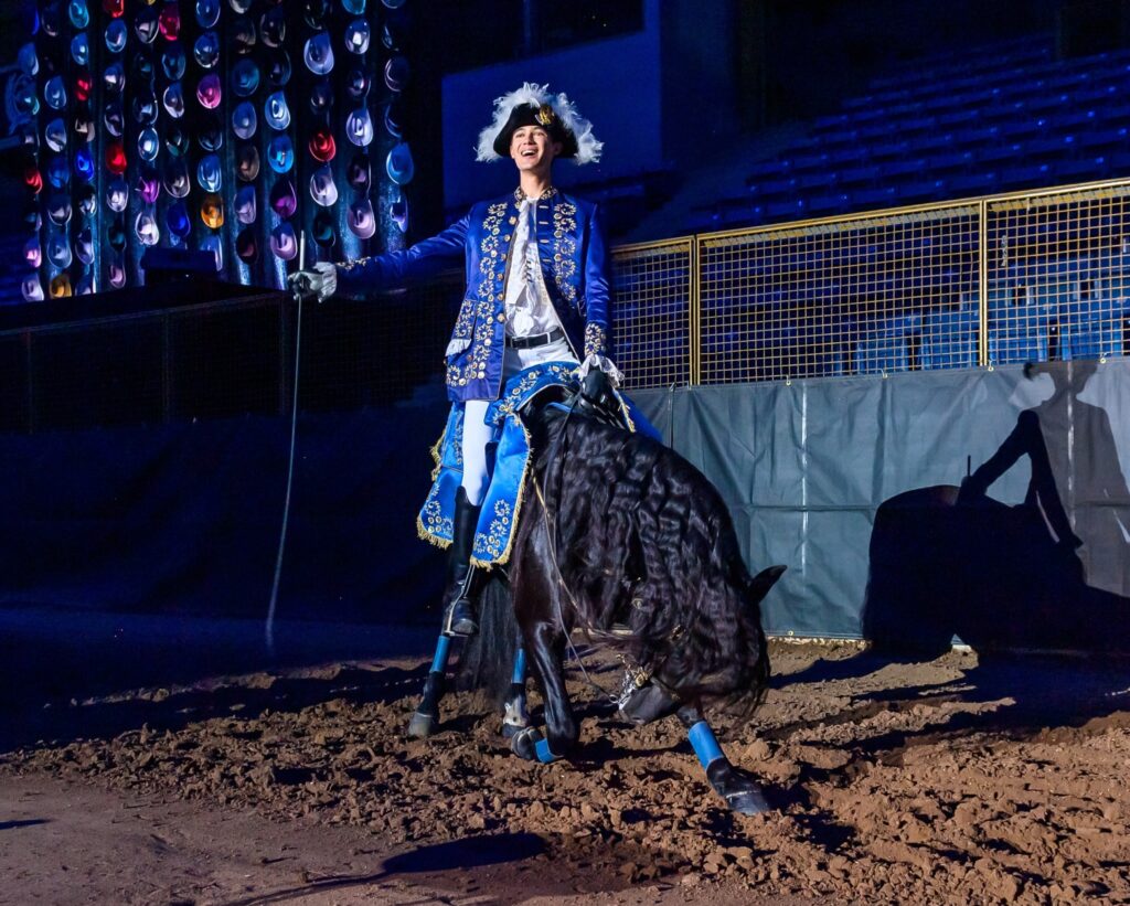 Horseman Nicolas Diaz waves to the audience while his horse takes a bow