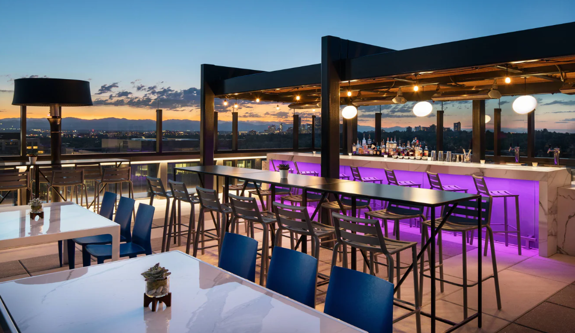 A rooftop bar at the Jaquard hotel with Denver sunset