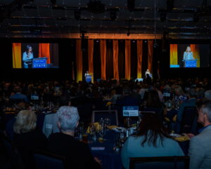 An audience watches the State of the State program